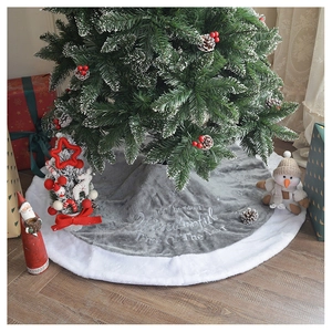 Detail of grey plush Christmas tree skirt with white fur edge and festive embroidery