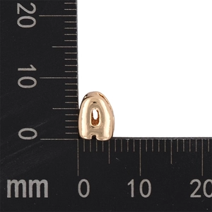 Detailed macro shot of a mini KC gold bubble letter 'a' pendant showing its 8mm size