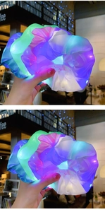 Detail shot of glowing LED scrunchies in green, purple, and white organza fabric