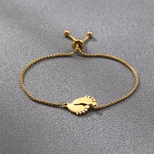 Detail of adjustable gold baby feet pendant bracelet with smooth metal slider clasp