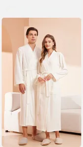 Detail view of milk white couple bathrobe with absorbent towel fabric and kimono collar