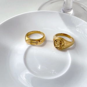 Vintage gold angel embossed signet ring set with delicate floral engraving details