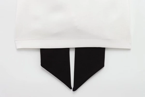 Close-up of contrast black and white patchwork hem with fine textile stitching detail