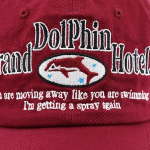 Detailed macro view of 3D dolphin embroidery on washed cotton baseball cap
