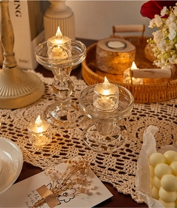Cozy home scene featuring glass candle holders and warm LED tea lights on lace