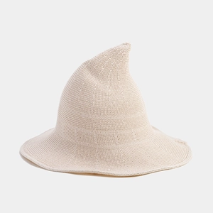 Detailed view of the fine knit texture and pointed curve of this cream witch sun hat