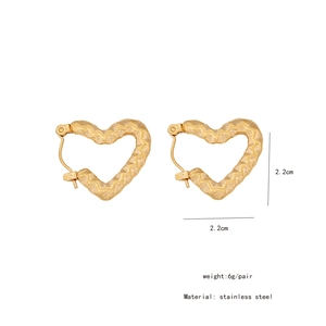 Detailed view of gold hammered heart earrings in stainless steel with size measurements