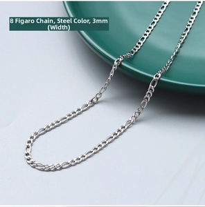 Detailed 3mm steel Figaro chain necklace shown on a green ceramic plate