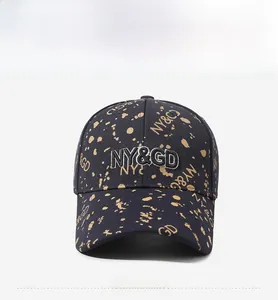 Detail of navy twill baseball cap with yellow splatter print and NY&GD embroidery