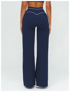 Detail of navy blue high-waist yoga pants featuring white contrast stitching and soft fabric