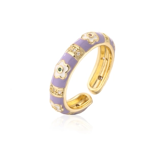 Detail of 18K gold plated flower ring featuring lavender enamel and zircon inlay