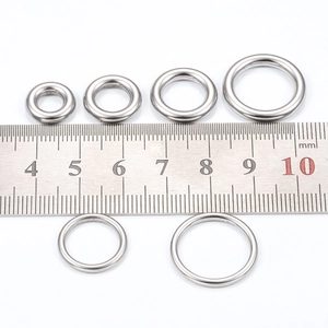 Polished stainless steel jump rings for jewelry making shown with metric ruler scale
