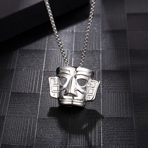 Ancient Sanxingdui face mask pendant in silver finish on a dark textured background