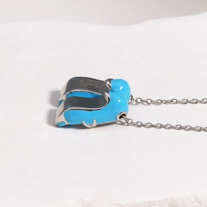 Detailed view of silver ballerina shoe pendant with blue enamel on O-chain necklace