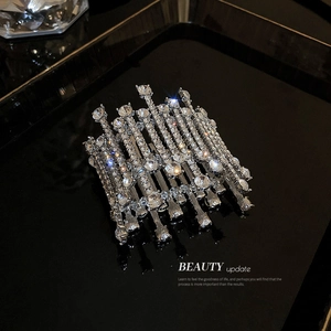 Elegant silver openwork bracelet with sparkling crystals and rhinestones on black background