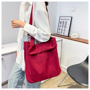 Deep red large nylon tote bag with smooth texture and matching wide shoulder strap