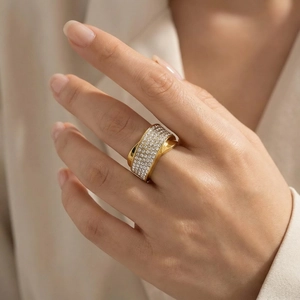 Detail of wide gold-plated stainless steel ring with multi-row pave crystal settings