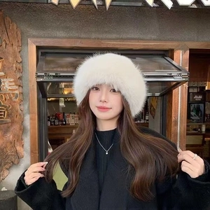 Detail of white faux fur winter bucket hat with fluffy texture and thick thermal lining