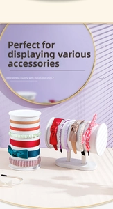 Detail view of white velvet headband organizers featuring bows and pearls in a soft-lit room