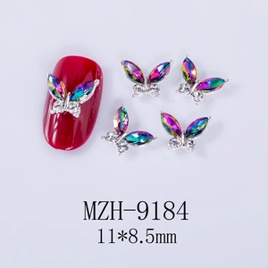 Macro shot of 11x8.5mm silver alloy 3D butterfly nail art charms with aurora rhinestones