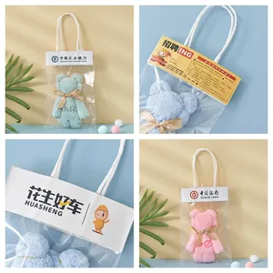 Blue and pink coral fleece towel bears in transparent gift bags with handles