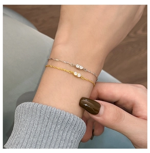 Detail shot of gold and silver S925 sterling silver bracelets with sparkling zircon