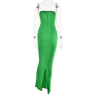 Detail of green backless dress featuring a rear zipper and elegant slit hemline