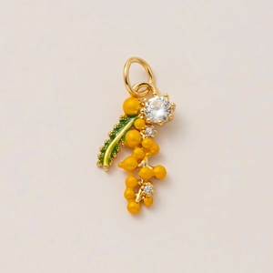 Detail of 18K gold plated pendant featuring yellow berries and a green enamel leaf
