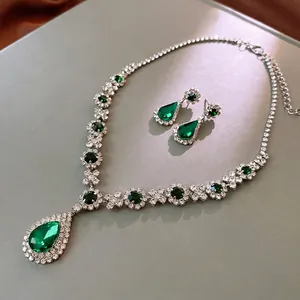 Luxury silver necklace and earring set with green pear-shaped stones and small diamonds