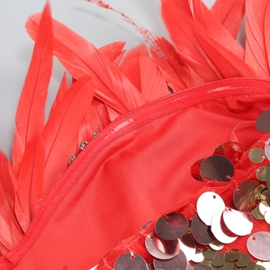 Detail of red sequins and feather trim with invisible zipper on evening dress