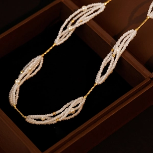 Elegant multi-layer pearl necklace with white seed beads and gold metal accents