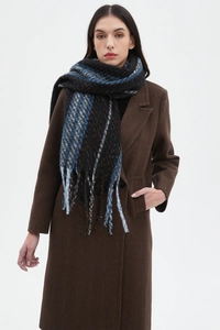 Detailed view of the thick wool texture and tassel trim on this striped black-blue scarf