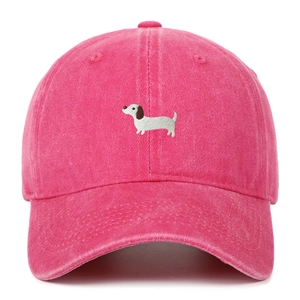 Front view of hot pink baseball cap featuring detailed dachshund dog embroidery