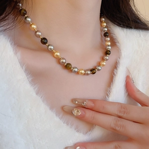 Vue détaillée du collier vintage français en œil de tigre et perles sur un modèle