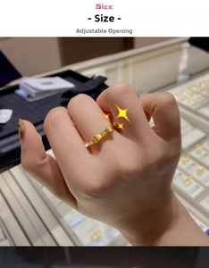 Detail of adjustable bow ring in brushed 18K gold finish with sizing information