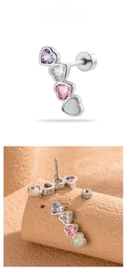 Detailed view of four colorful heart-shaped zirconia stones on a steel screw stud piercing