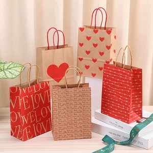 Valentine LOVE kraft paper gift bags with hearts in red and brown on white book stand