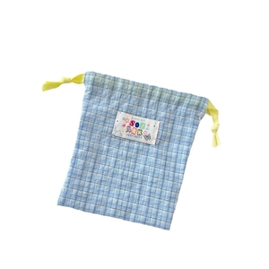 Blue plaid drawstring storage bag with yellow cords and cute artistic fabric label