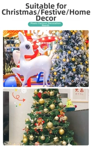 Vertical view of gold Christmas ornaments and reindeer figures on a decorated holiday tree