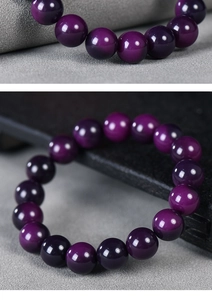 Macro detail of polished purple Bodhi root beads showing smooth texture and deep violet tones