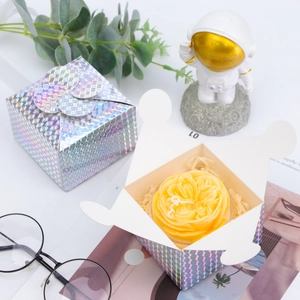 Detailed top view of a laser iridescent gift box with yellow rose scented candle and raffia