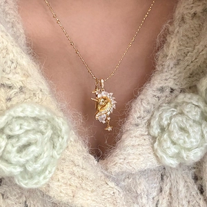 18k gold plated unicorn pendant necklace with zircons worn on a white sweater