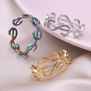 Detail of minimalist infinity symbol rings in rainbow, silver, and gold finishes