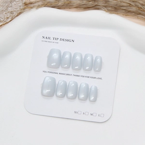 Cat-eye light blue press-on nails set in square-oval shape on white display card