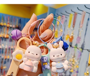 Detail of cute resin cartoon animal nail clipper keychains with colorful wire rings