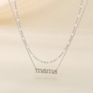 Detail of silver double-layered MAMA necklace with white beads on silk background