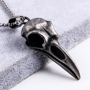 Close-up of vintage crow skull pendant in antique silver finish with detailed texture