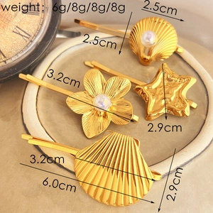 Set of four gold-finish metal hair clips with pearls and shell-shaped designs