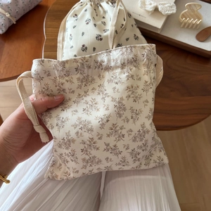 Close-up of floral drawstring cotton bag showing texture and rustic cotton rope