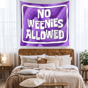Detail of purple tapestry with NO WEENIES ALLOWED text hanging over a bed headboard
